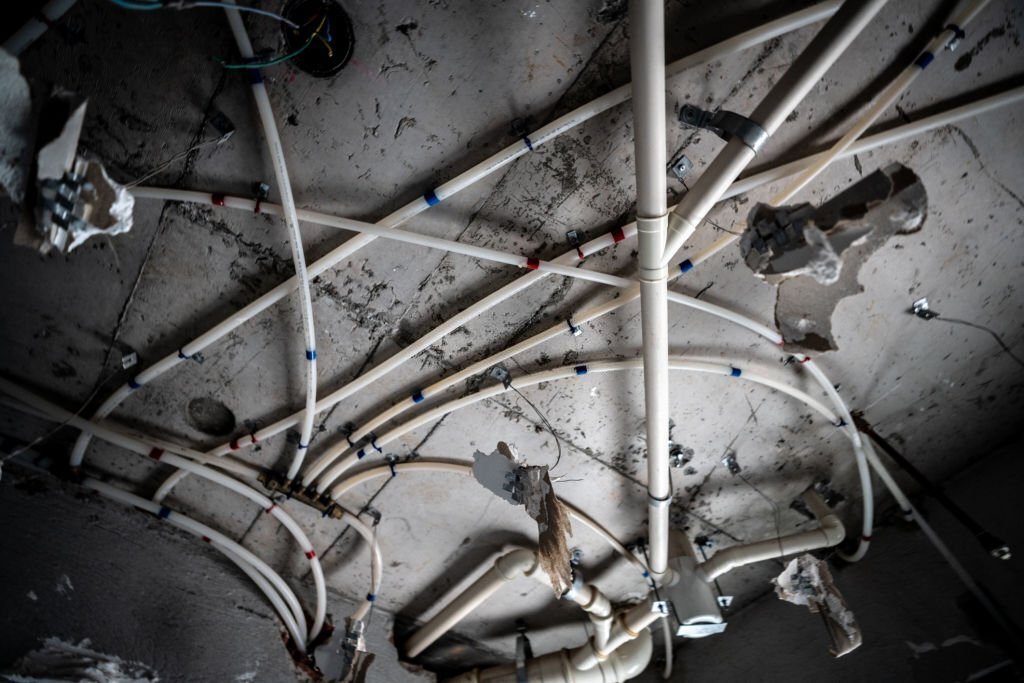 Unfinished water installation in an apartment's ceiling