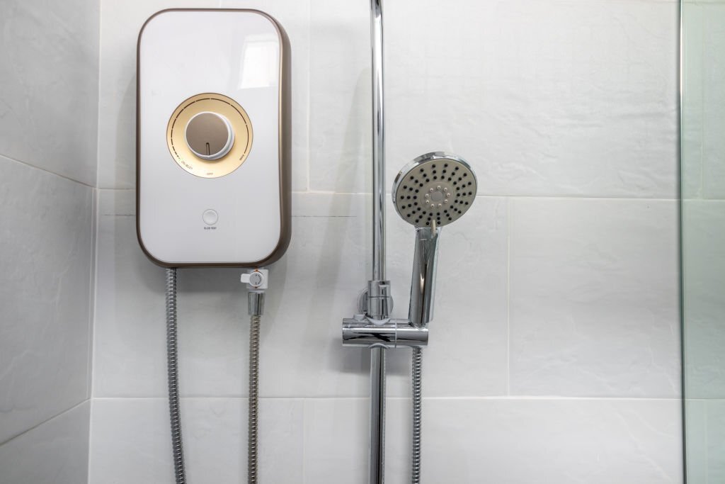 Shower and water heater in a white bathroom. Shower and water heater in a white bathroom.
