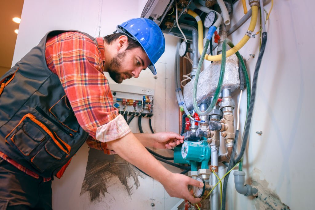 Technician installing heating system Technician installing heating system