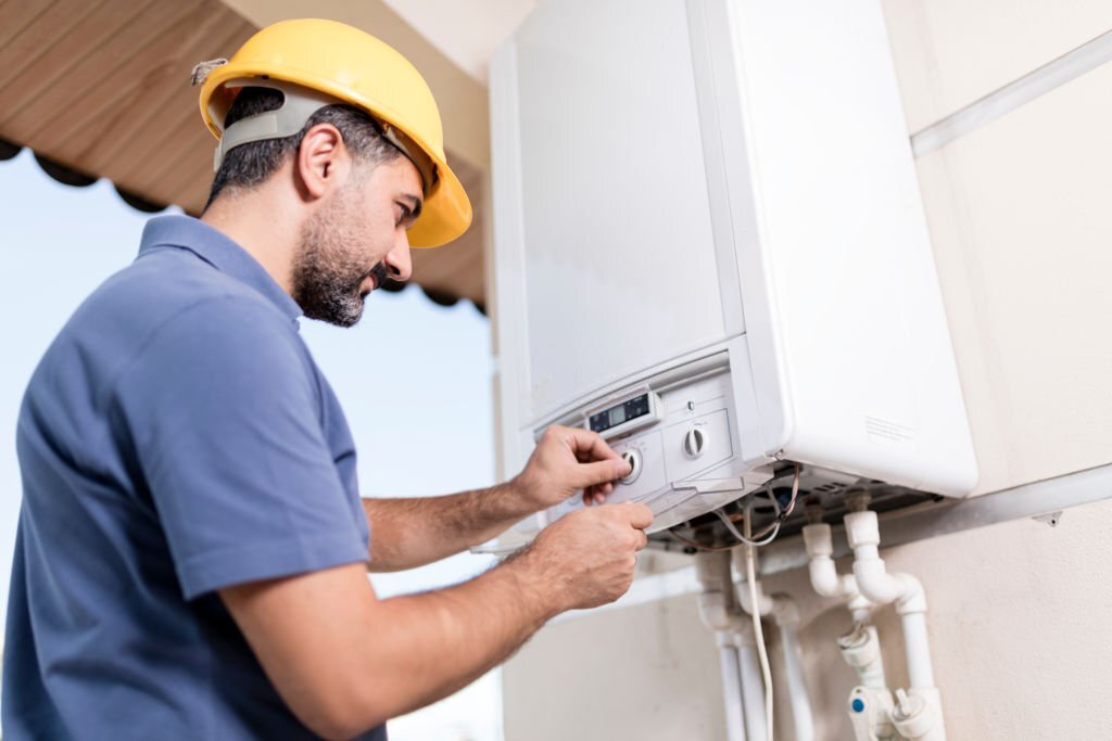 Boiler technician working in home. Boiler technician working in home.