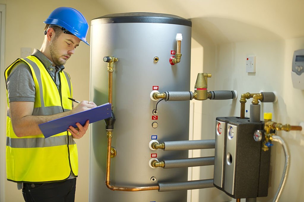 engineer checks solar thermal control panel engineer checks solar thermal control panel