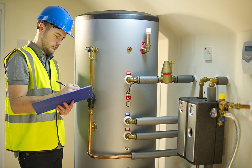 engineer checks solar thermal control panel